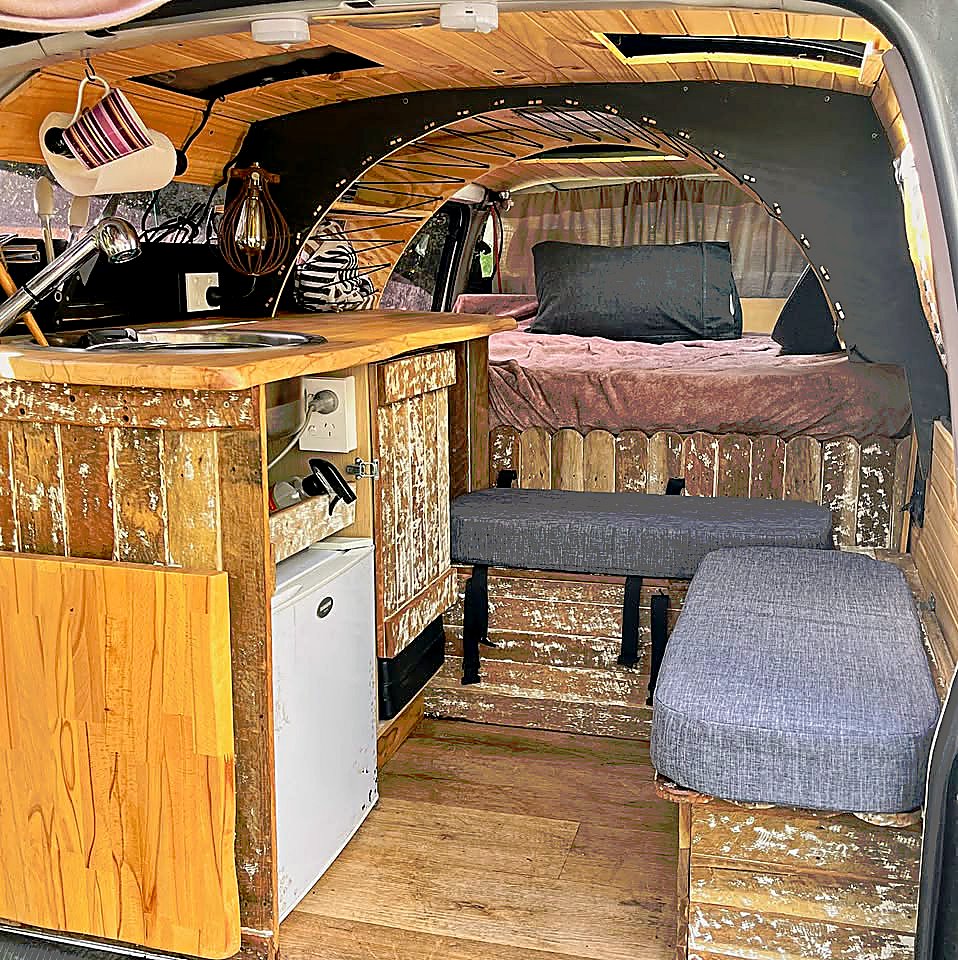 Interior — kitchen, lounge seating, and bed
