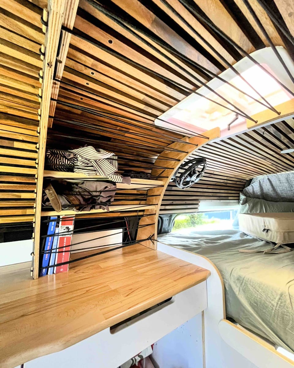 Overhead storage shelves and double bed