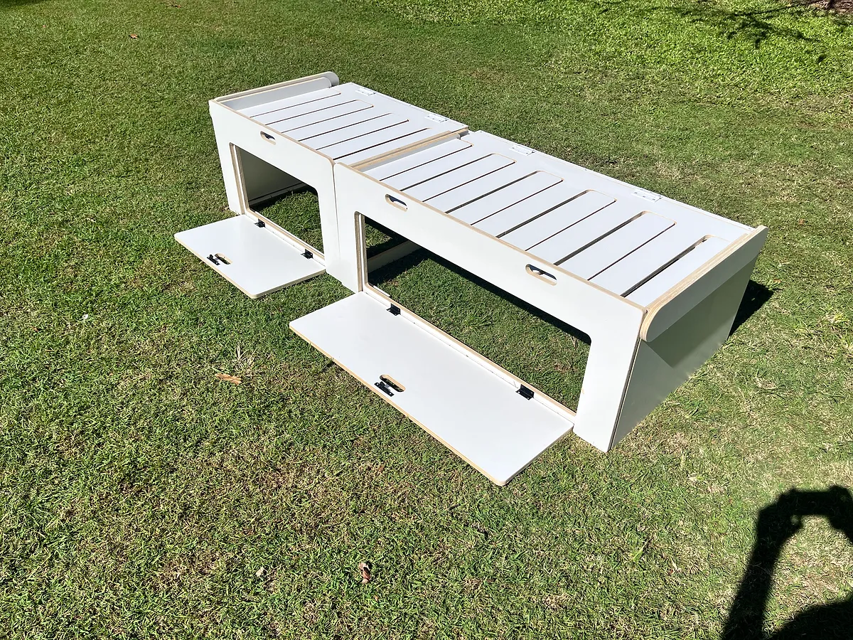 White comb bed with front hatches open showing internal storage