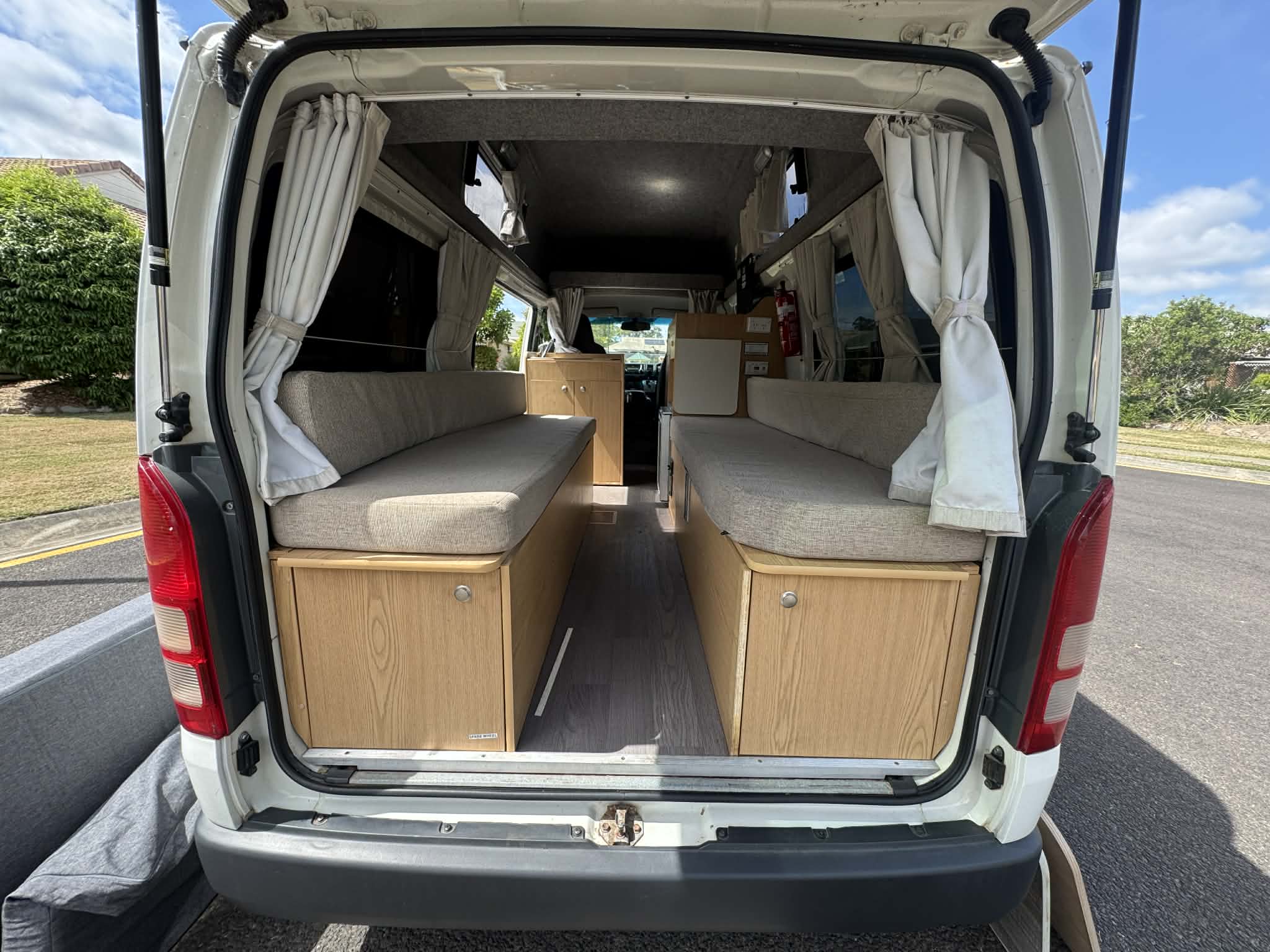 Rear doors open — twin beds and underbed storage