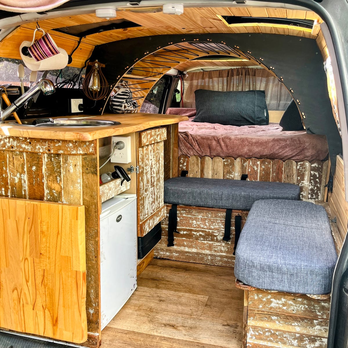 Custom Hiace interior with reclaimed-wood cabinetry